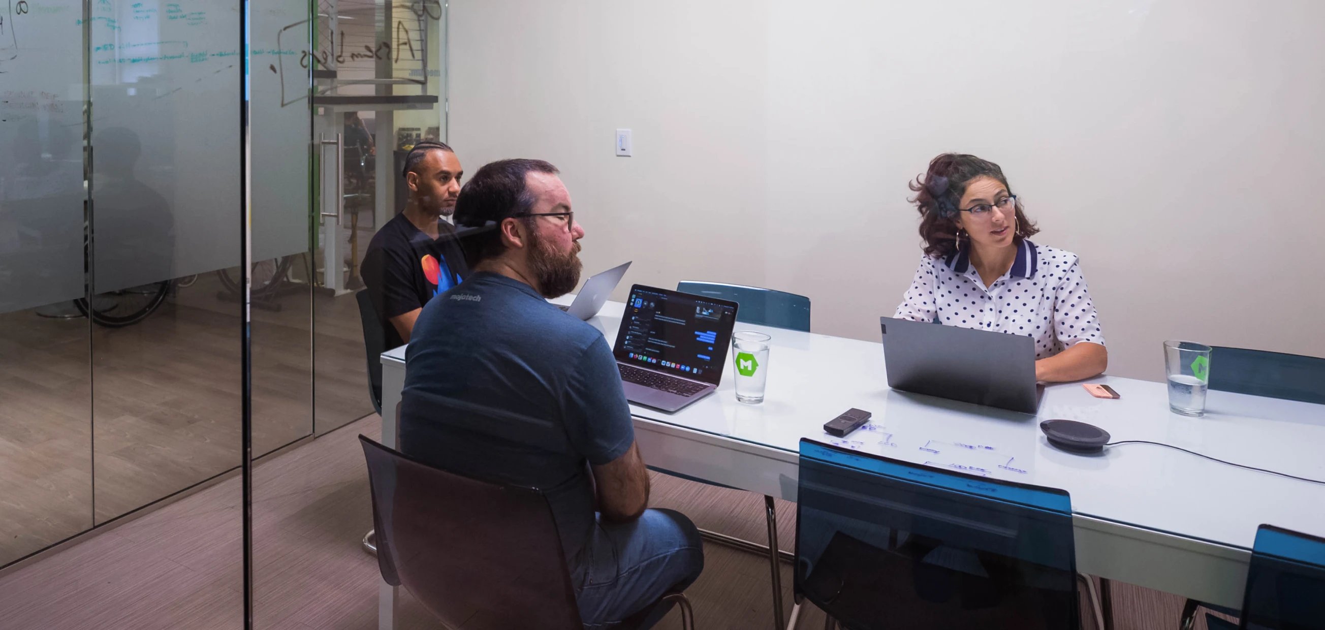 MojoTech product managers in a conference room strategizing with clients.